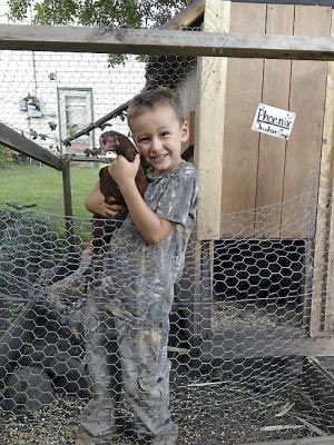 Phoenix Turnbull holds his pet hen.