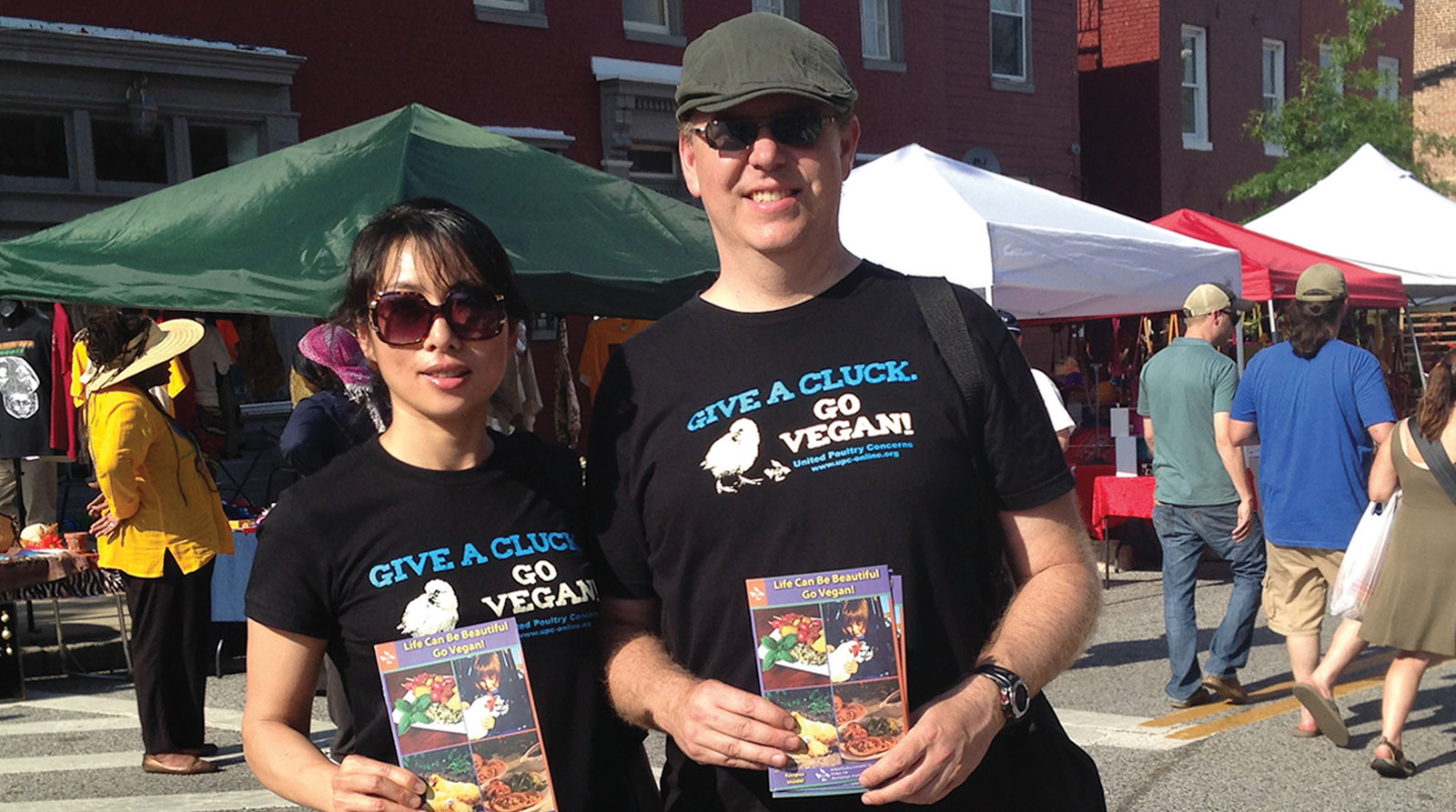 Liqin and Franklin on the street handing out pamphlets