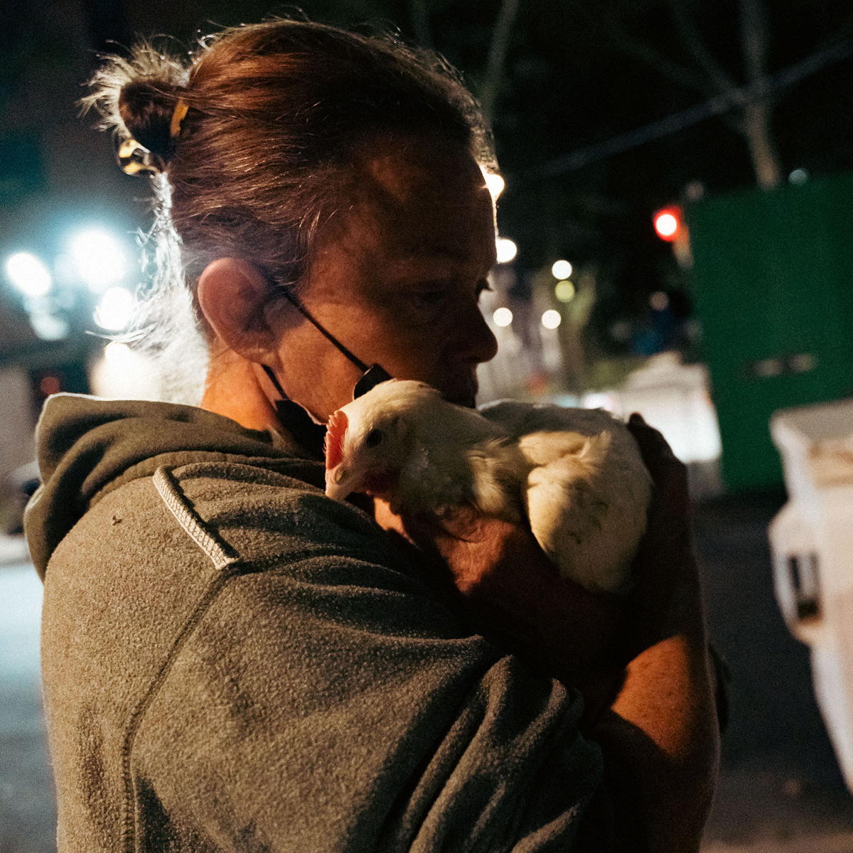 Woman cradling a chicken